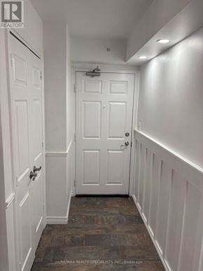 Milton (De Dempsey) condo for rent - A hallway with white doors and a wooden floor.
