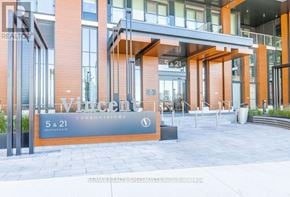 Vaughan (Vaughan Corporate Centre) condo for rent - The entrance to a building with a sign that reads "5 & 21".