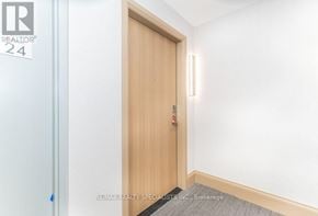 Vaughan (Vaughan Corporate Centre) condo for rent - A wooden door with a handle and a number 24 on the wall above it.