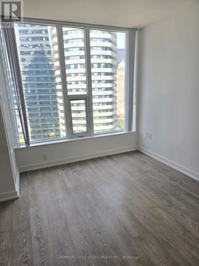 Toronto (Waterfront Communities) condo for rent - A room with a view of a city skyline through large windows.
