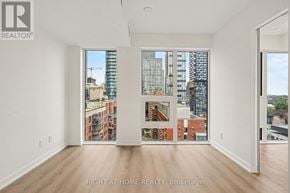 Toronto (Church-Yonge Corridor) condo for rent - A large empty room with a view of the city.