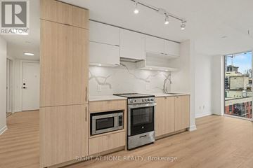 Toronto (Church-Yonge Corridor) condo for rent - A modern kitchen with wooden cabinets and stainless steel appliances.