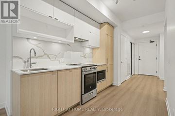Toronto (Church-Yonge Corridor) condo for rent - A kitchen with wooden cabinets and a stainless steel oven.