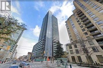 Toronto (Mount Pleasant West) condo for rent - A modern glass skyscraper stands tall in the city center.