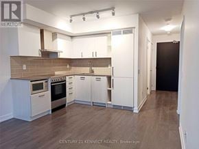 Toronto (Mount Pleasant West) condo for rent - A kitchen with white cabinets and a brick backsplash.