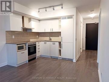 Toronto (Mount Pleasant West) condo for rent - A kitchen with white cabinets and a brick backsplash.