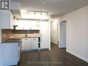 Toronto (Mount Pleasant West) condo for rent - A kitchen with white cabinets and a brown countertop.