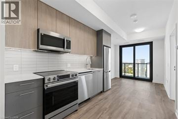 Kitchener condo for rent - A modern kitchen with a stainless steel oven and microwave.
