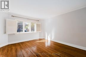 Toronto (Birchcliffe-Cliffside) apartment for rent - A room with wooden floors and a window with blinds.