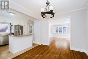 Toronto (Birchcliffe-Cliffside) apartment for rent - A well-lit kitchen with white cabinets and a wooden floor.