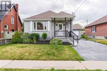 Oshawa (O'neill) apartment for rent - A small house with a front porch and a driveway.