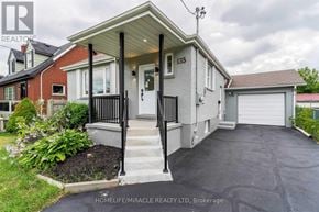 Oshawa (O'neill) apartment for rent - A house with a front yard and a garage is for sale.