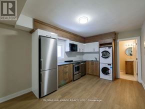 Toronto (Playter Estates-Danforth) apartment for rent - A kitchen with a refrigerator, microwave, oven, and washing machine.