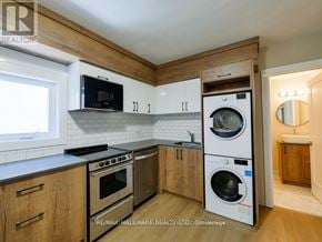 Toronto (Playter Estates-Danforth) apartment for rent - A kitchen with a washer and dryer built into the cabinetry.