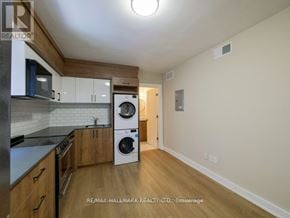 Toronto (Playter Estates-Danforth) apartment for rent - A kitchen with a washing machine built into the cabinetry.