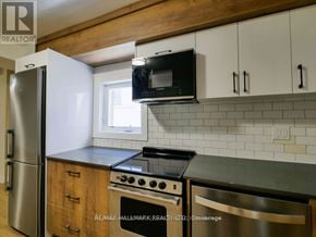 Toronto (Playter Estates-Danforth) apartment for rent - A kitchen with a stainless steel refrigerator, microwave, and oven.