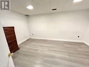 Toronto (Woburn) apartment for rent - A room with a wooden door and grey flooring.