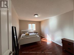 Richmond Hill (Bayview Hill) apartment for rent - A bedroom with a bed, dresser, and window.