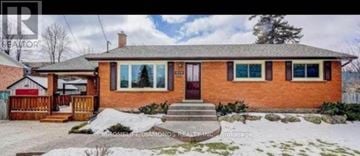 Burlington (Freeman) apartment for rent - A small house with a brown door and windows is surrounded by snow.