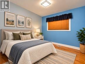 Burlington (Freeman) apartment for rent - A bedroom with a bed, a nightstand, a lamp, and a plant.