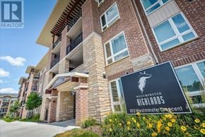 Centre Wellington (Fergus) condo for rent - A brick building with a sign that says Westminster Highlands.