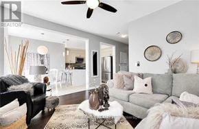 Clarington (Newcastle) apartment for rent - A living room with a grey couch, a black chair, and a white coffee table.