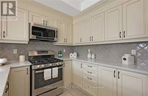 Clarington (Newcastle) apartment for rent - A kitchen with a stove, microwave, and cabinets.