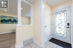 Toronto (Rexdale-Kipling) apartment for rent - A white door with a glass window and a black mat in front of it.