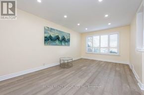 Toronto (Rexdale-Kipling) apartment for rent - A spacious room with a glass table and a painting on the wall.