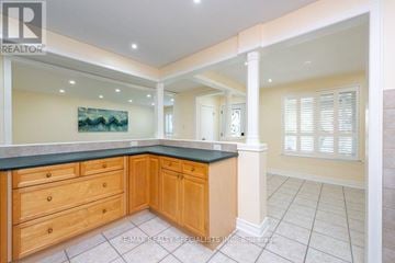 Toronto (Rexdale-Kipling) apartment for rent - A kitchen with wooden cabinets and a painting on the wall.