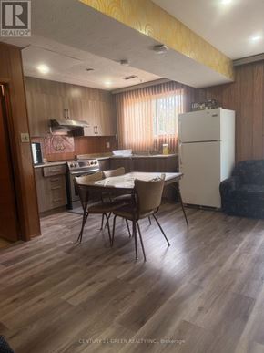 Toronto (Clairlea-Birchmount) apartment for rent - A kitchen with wooden floors and a white refrigerator.