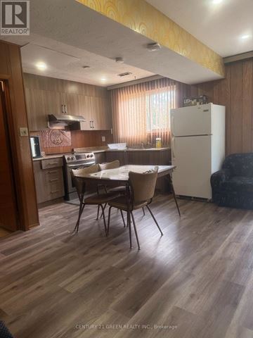 Toronto (Clairlea-Birchmount) apartment for rent - A kitchen with wooden floors and a white refrigerator.