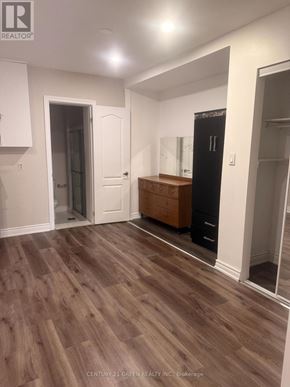 Toronto (Clairlea-Birchmount) apartment for rent - A room with wooden flooring and white walls.