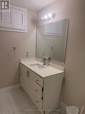 Toronto (Clairlea-Birchmount) apartment for rent - A bathroom with a sink, mirror, and cabinets.