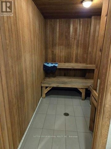 Markham (Thornhill) condo for rent - A wooden room with a bench and a hole in the floor.