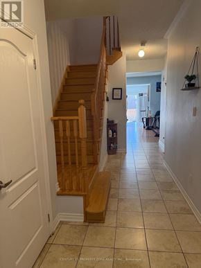 Brampton (Credit Valley) apartment for rent - A hallway with a staircase and a door on the left.