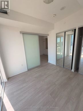 Toronto (Church-Yonge Corridor) condo for rent - A room with a sliding glass door and wooden flooring.