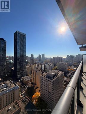 Toronto (Church-Yonge Corridor) condo for rent - A cityscape with a bright sun in the sky.