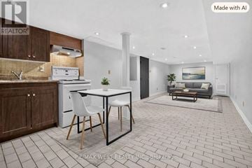 Toronto (Little Portugal) townhouse for rent - A modern kitchen with a dining table and chairs.
