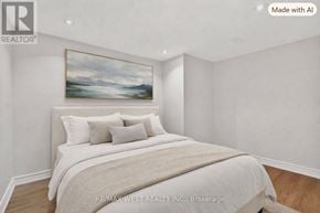 Toronto (Little Portugal) townhouse for rent - A bedroom with a large bed and a painting on the wall.
