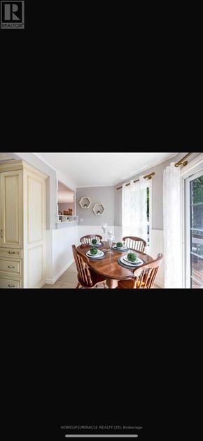 Oshawa (Mclaughlin) apartment for rent - A dining room with a wooden table and chairs.
