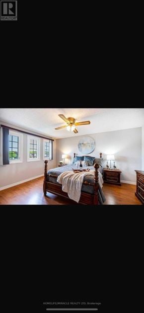 Oshawa (Mclaughlin) apartment for rent - A bedroom with a bed, a ceiling fan, and a window.
