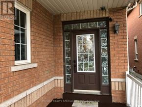 Brampton (Madoc) apartment for rent - A brown door with a glass window is the main focus of the image.