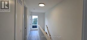 St. Catharines (Oakdale) townhouse for rent - A hallway with a door leading to a balcony.