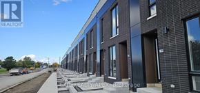 St. Catharines (Oakdale) townhouse for rent - A row of modern townhouses with a clear sky in the background.