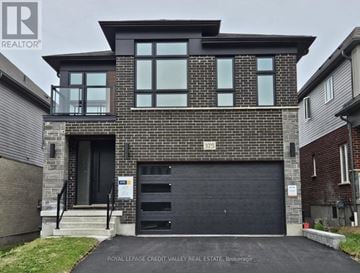 Waterloo apartment for rent - A modern house with a black garage door is for sale.