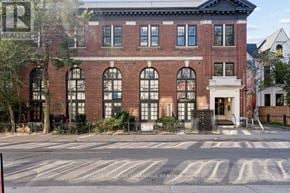Toronto (Palmerston-Little Italy) condo for rent - A brick building with a sign that says REALTOR.