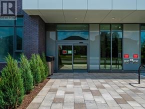 Mississauga (Hurontario) condo for rent - The front of a building with a glass door and windows.