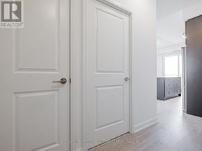 Mississauga (Hurontario) condo for rent - A white door with a gold handle is closed.
