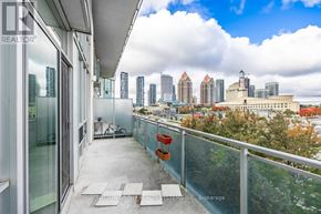 Mississauga (City Centre) condo for rent - A balcony with a glass railing overlooking a city skyline.